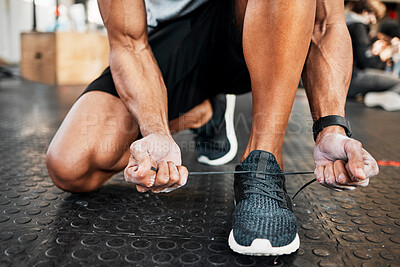 Buy stock photo Shot of a man tying his laces before a workout