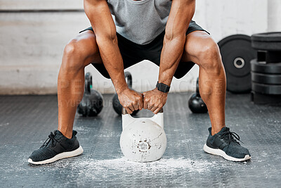 Buy stock photo Shot of a man completing squats with a kettlebell