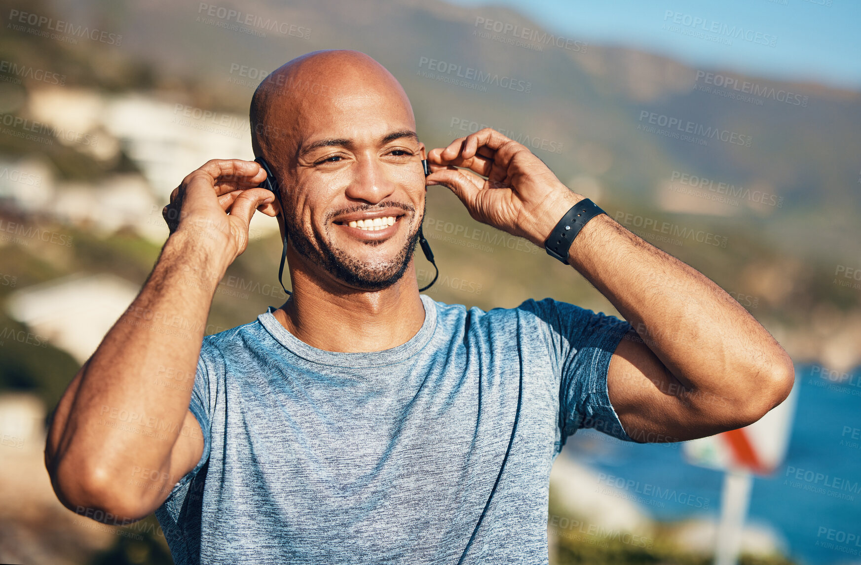 Buy stock photo Happy, fitness and sea with African man and headphones for music or podcast streaming. Outdoor, exercise and runner with audio, wellness and marathon training on beach path with health in Seychelles