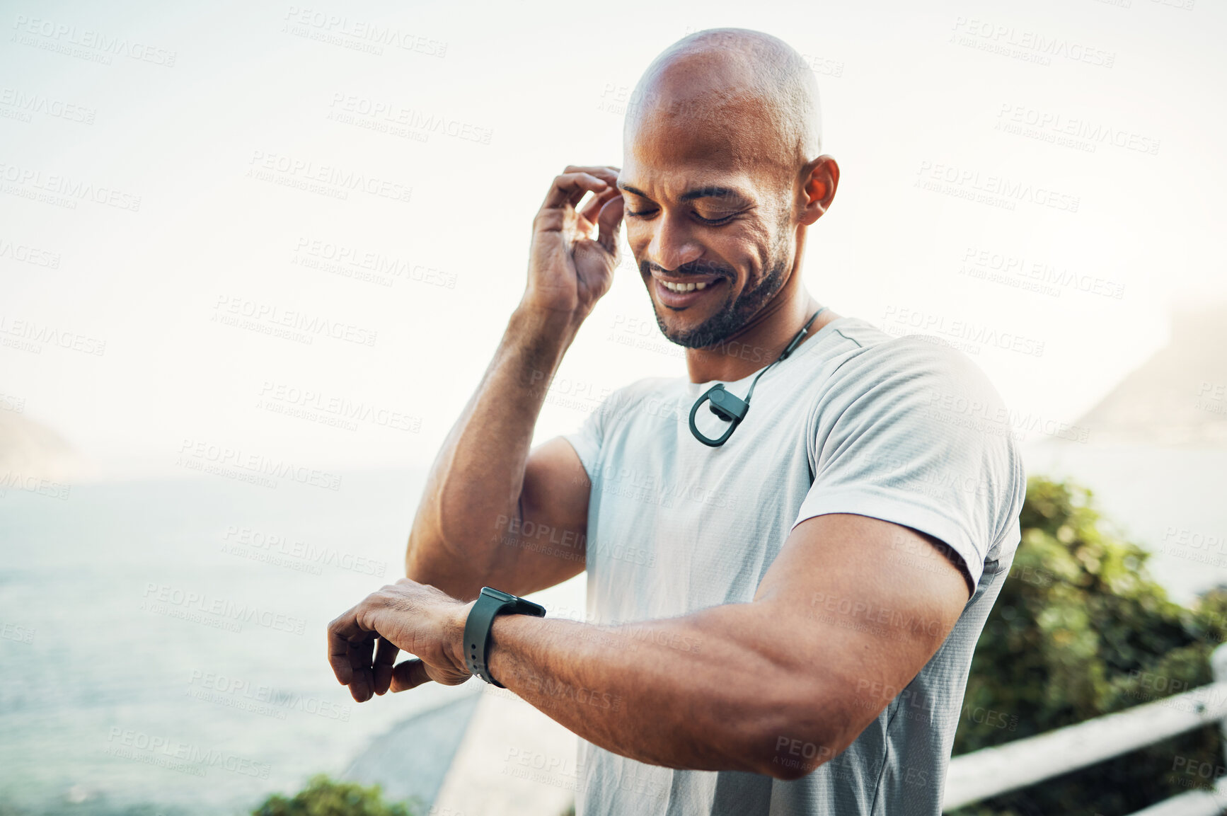 Buy stock photo Shot of a man using his watch to track his pulse while out for a workout