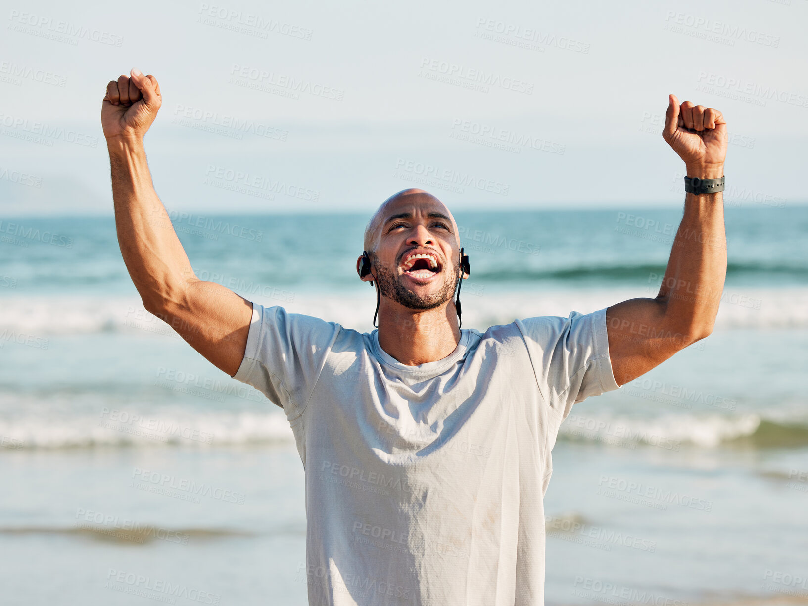 Buy stock photo Shot of a young man celebrating on the beach