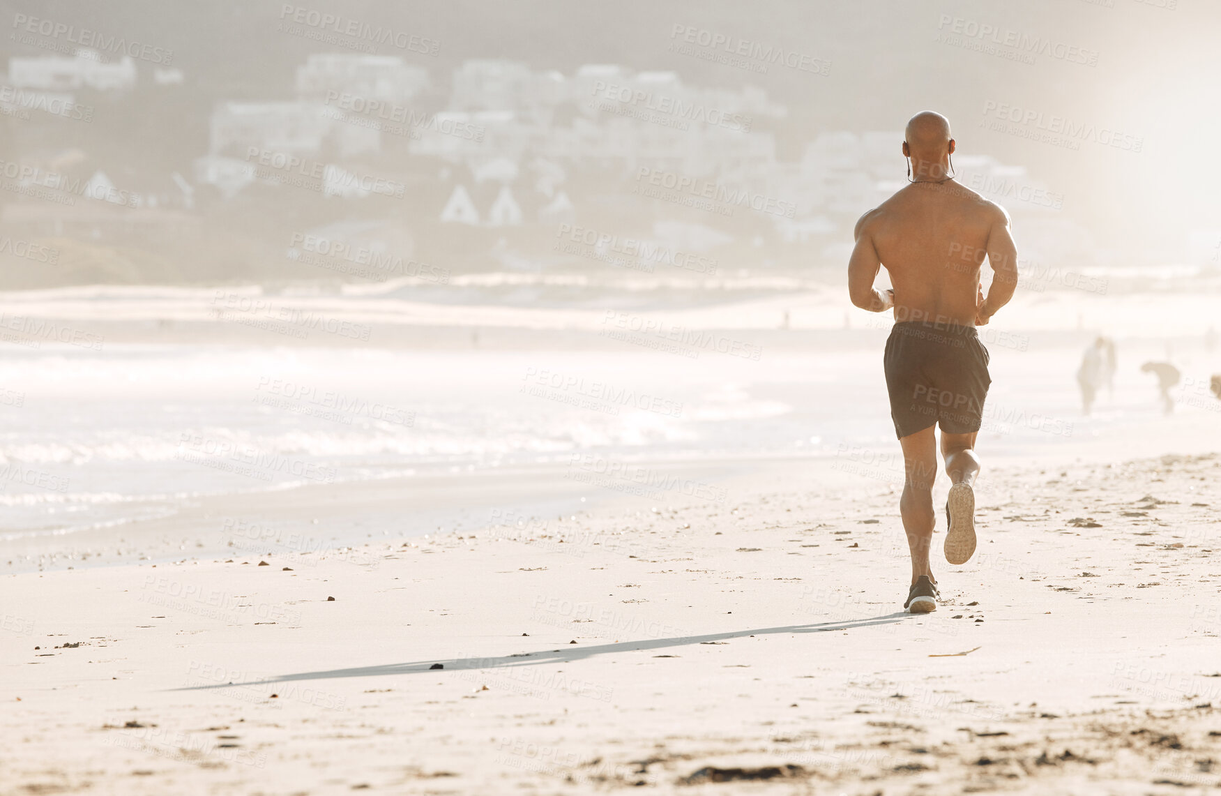 Buy stock photo Shot of a man running on the beach