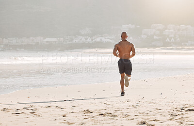 Buy stock photo Shot of a man running on the beachv