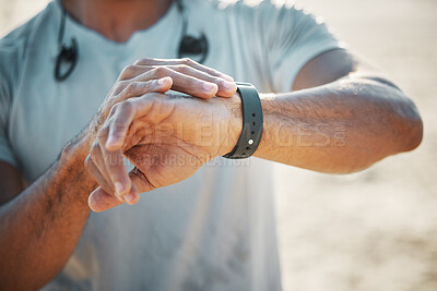 Buy stock photo Shot of a unrecognizable man using his watch to track his pulse while out for a workout