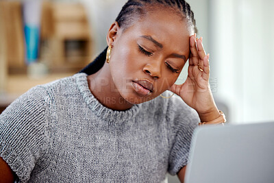 Buy stock photo Mental health, businesswoman with a headache and tired with laptop at her desk in a modern office workplace. Burnout or fatigue, depression or stress and African female person sad at her workstation