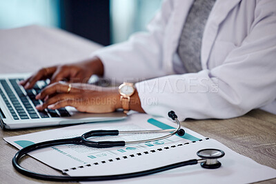 Buy stock photo Closeup, hands and doctor with a laptop, stethoscope and typing with connection, documents and telehealth. Black woman, female person or employee with a folder, medical equipment and digital planning