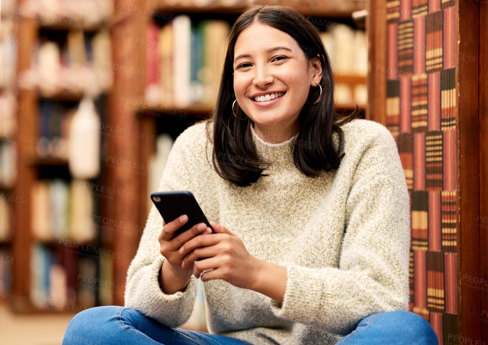 Buy stock photo Portrait, girl and student in library, cellphone and typing for research, social media and relaxing with smile. Face, person and woman with smartphone, books and college with contact or happiness