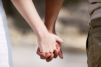 Buy stock photo Interracial couple, holding hands and nature with love for care, support or companionship. Closeup of man and woman touching in partnership, relationship or lovers walking together in outdoor bonding