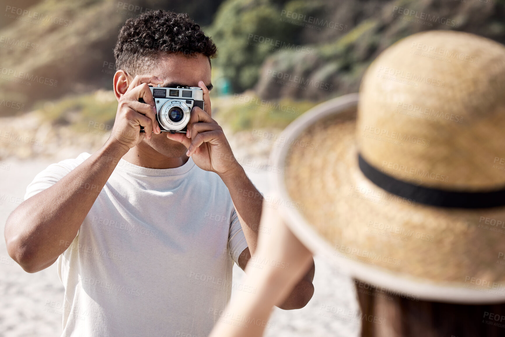 Buy stock photo Man, camera and photography with woman at beach, couple on holiday for travel and memory together. Honeymoon, date or anniversary getaway with retro tech for picture taking and adventure outdoor