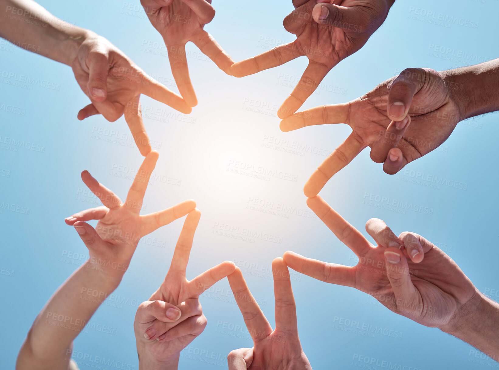 Buy stock photo People, hands and star with fingers below in unity, teamwork or community on a blue sky background. Closeup or low angle of group in solidarity or synergy with shape, sign or collaboration in nature