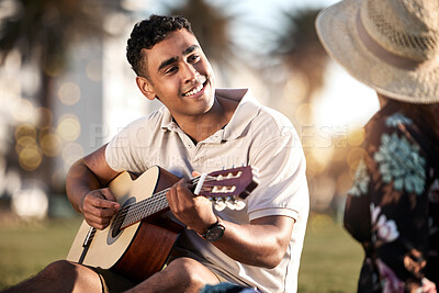 Buy stock photo Picnic, date and man with guitar for love, romance and anniversary in Puerto Rico. Couple, happy and music in outing on grass for summer, relax or happiness together at sunset with instrument in park