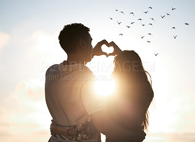 Buy stock photo Couple at sunset sky, heart hands in silhouette and nature to celebrate marriage, date or honeymoon. Summer, travel and tropical vacation, love hand sign with man and woman together in relationship.