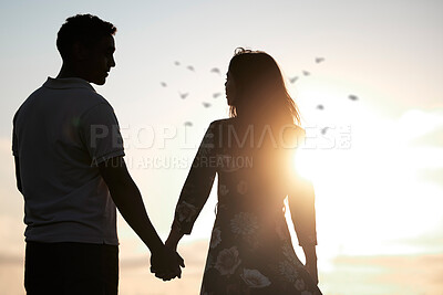 Buy stock photo Couple, silhouette and holding hands at romantic, destination, holiday or honeymoon in summer at sunset on vacation on date. Woman, man and relationship in love or together, memory and travel on trip