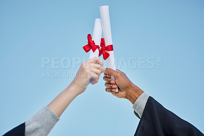 Buy stock photo Closeup shot of two unrecognisable graduates celebrating with their diplomas on graduation day