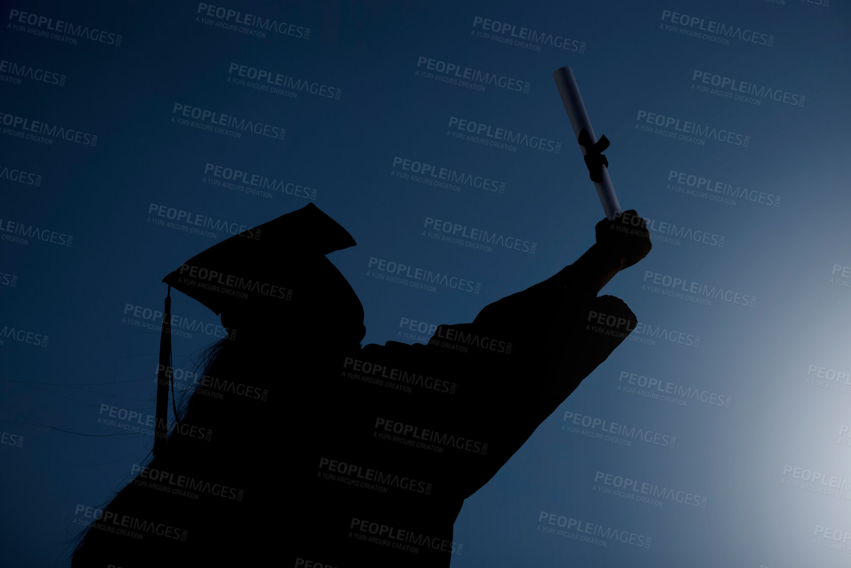 Buy stock photo Shot of the silhouette of a student celebrating on graduation day