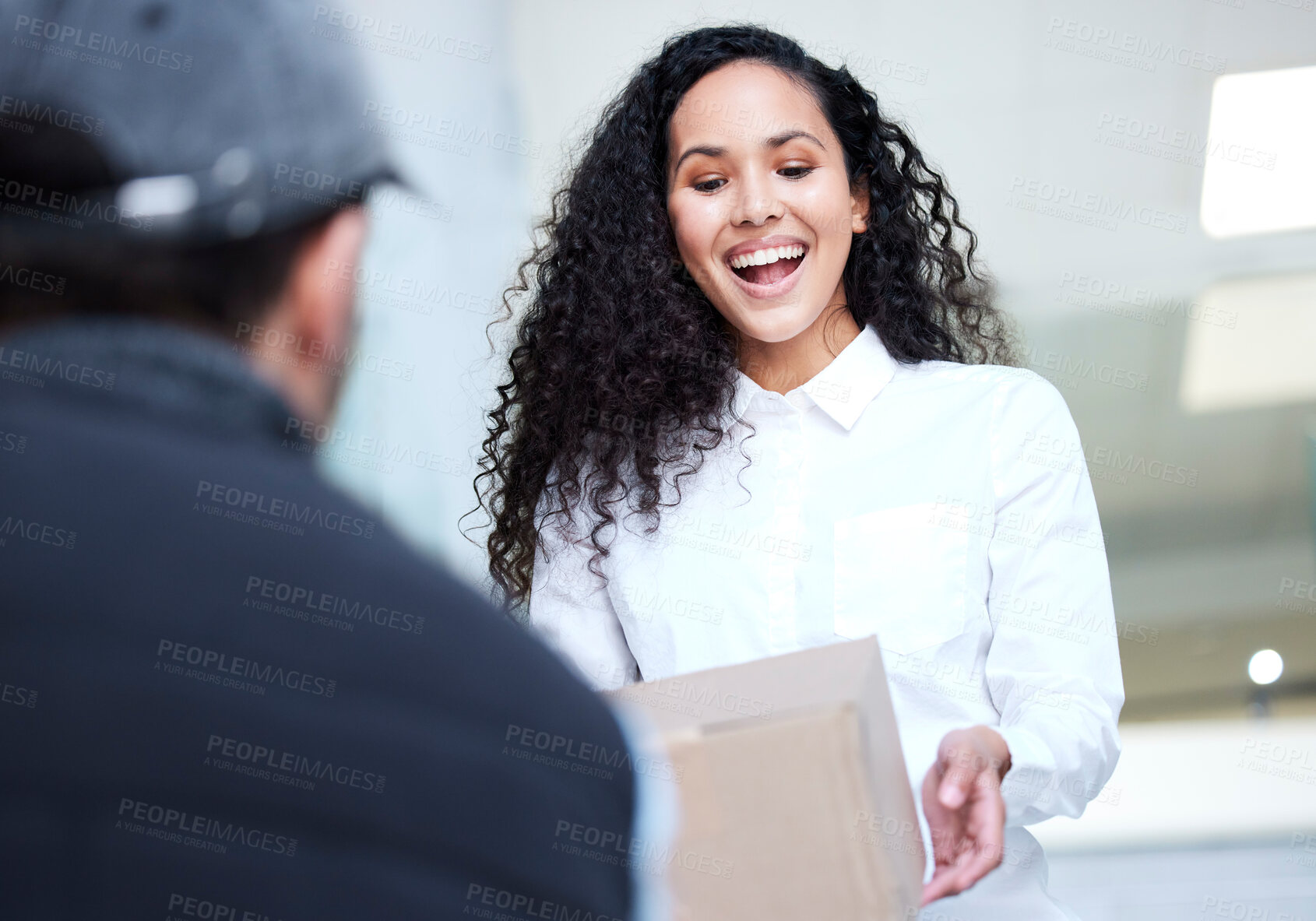 Buy stock photo Shot of a young woman receiving her delivery from the courier