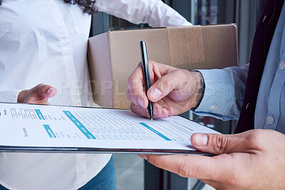 Buy stock photo Closeup shot of an unrecognisable delivery man filling in paperwork while making a delivery to a customer