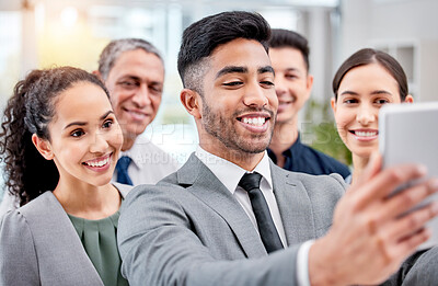 Buy stock photo Shot of a group of staff taking selfies using a digital tablet