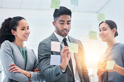 Buy stock photo Creative, writing and business people on glass board for teamwork schedule, project priority and reminder or solution. Sticky notes, collaboration and women, man and team for scrum and agile timeline
