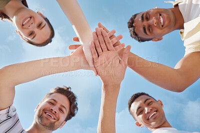 Buy stock photo Low angle shot of a group of young people stacking their hands