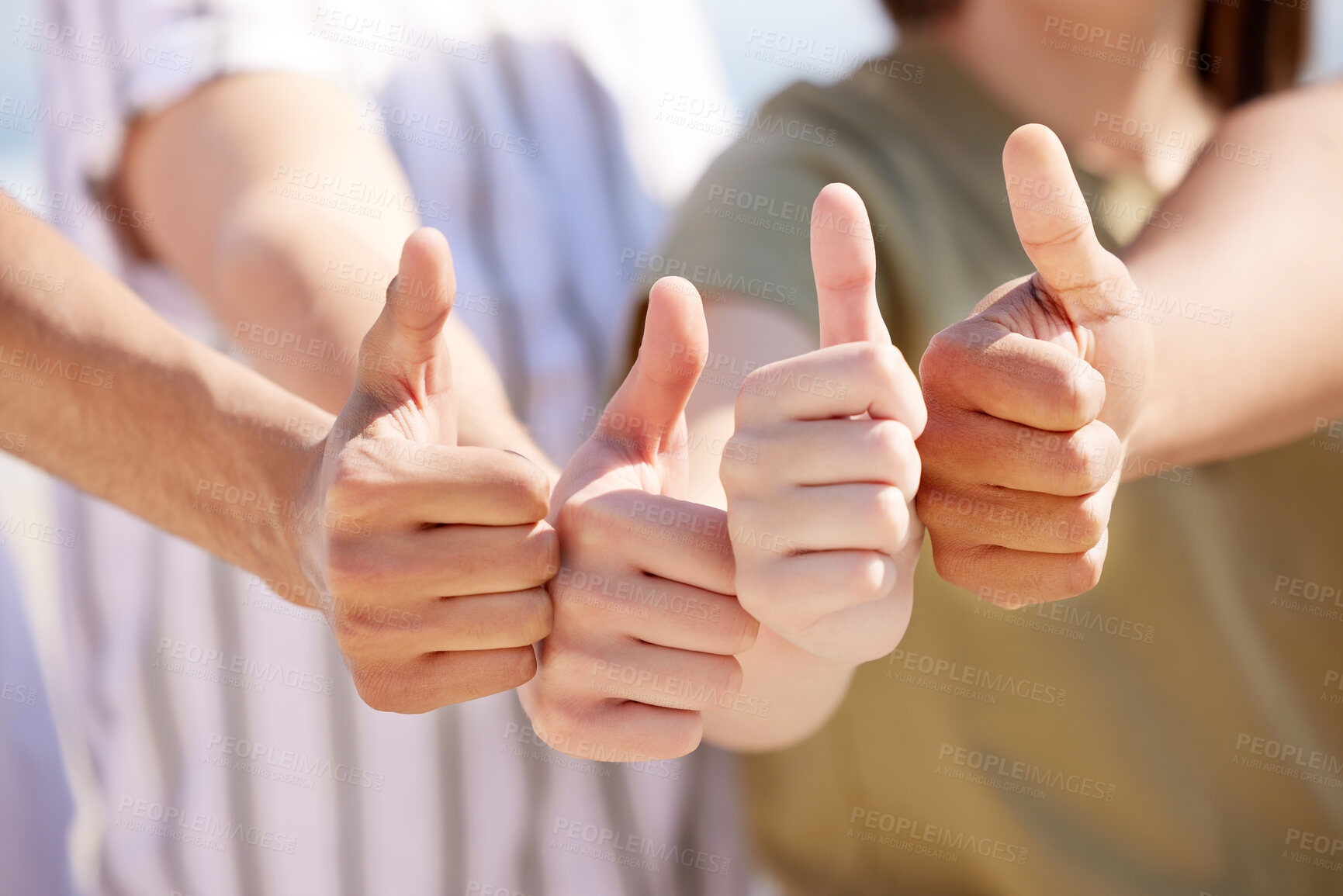 Buy stock photo Shot of a group of unrecognizable people showing a thumbs up outside