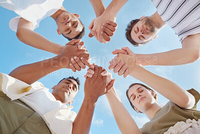 Buy stock photo Shot of a group of young people holding hands while praying outside