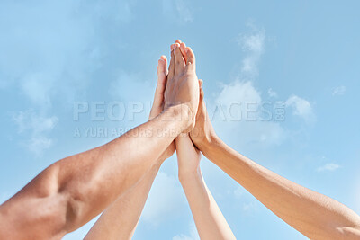 Buy stock photo Shot of a group of unrecognizable people giving each other a high five outside