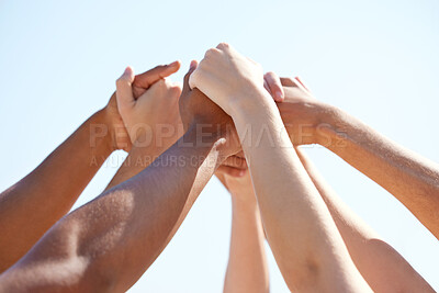 Buy stock photo Shot of a group of unrecognizable people holding hands outside