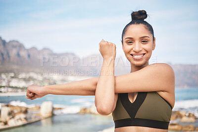 Buy stock photo Cropped portrait of an attractive athletic young woman warming up before a wrokout on the beach