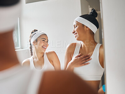 Buy stock photo Shot of two attractive young women chatting in the locker room at a tennis arena