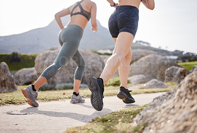 Buy stock photo Rearview shot of two women going for a run in a park