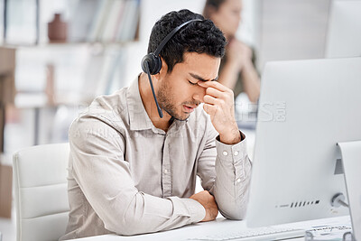 Buy stock photo Mental health, man with headache and headset at his desk with computer in a modern workplace office. Telemarketing or call center, sad or burnout and male person tired or depressed at his workstation