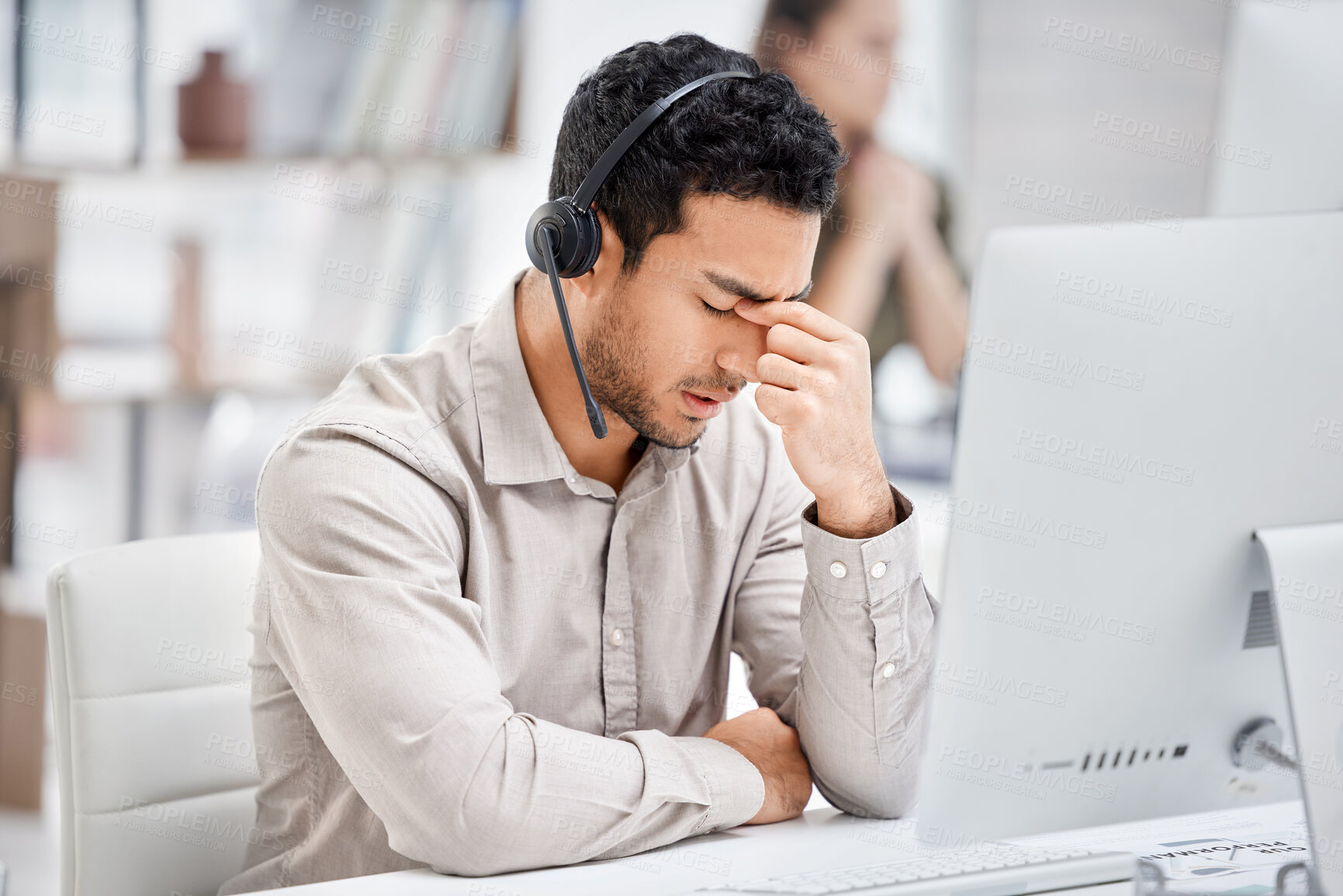 Buy stock photo Mental health, man with headache and headset at his desk with computer in a modern workplace office. Telemarketing or call center, sad or burnout and male person tired or depressed at his workstation