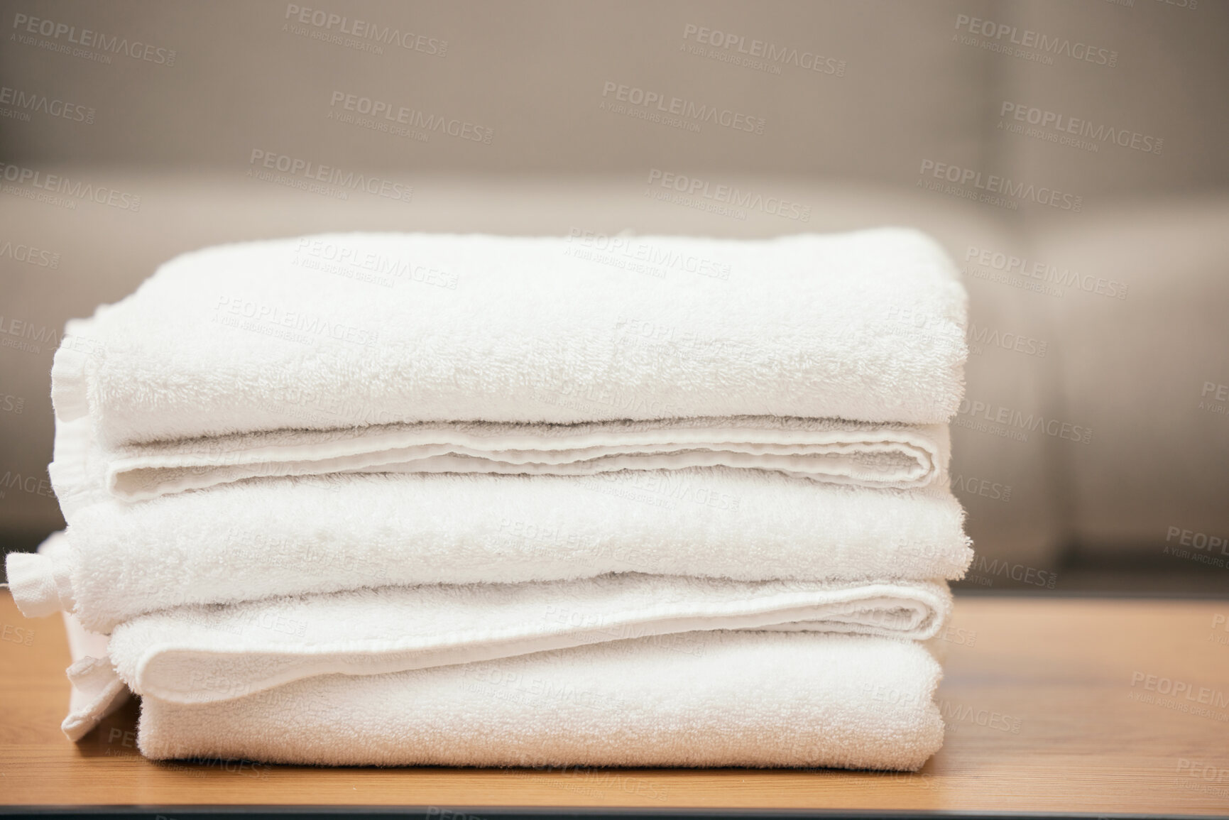 Buy stock photo Clean, laundry and soft towel on table for hospitality, cleaning service and white material of fabric. Fresh, textile and pile of linen cloth at home with texture for bathroom, health and hygiene