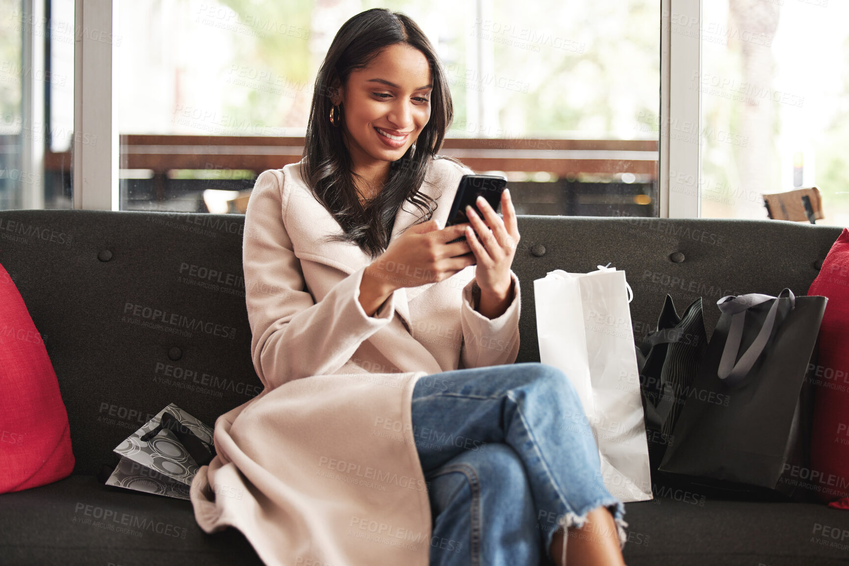 Buy stock photo Woman, reading and shopping in city with phone notification of sale, info and scroll social media. Girl, customer and relax on sofa with smartphone for virtual retail, store and ecommerce website