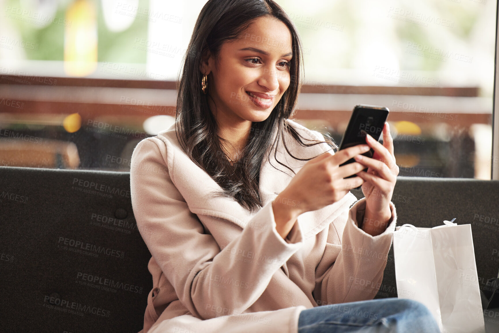 Buy stock photo Woman, reading and shopping in city with phone notification of sale, info and scroll social media. Girl, customer and relax on sofa with smartphone for virtual retail, store and ecommerce website