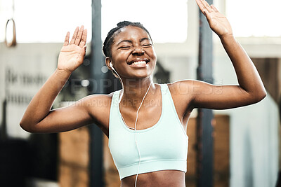 Buy stock photo Earphones, healthy and black girl in gym, happy and listening for exercise, online and streaming on app. Fitness, music and workout with technology, internet and radio for wellness and training