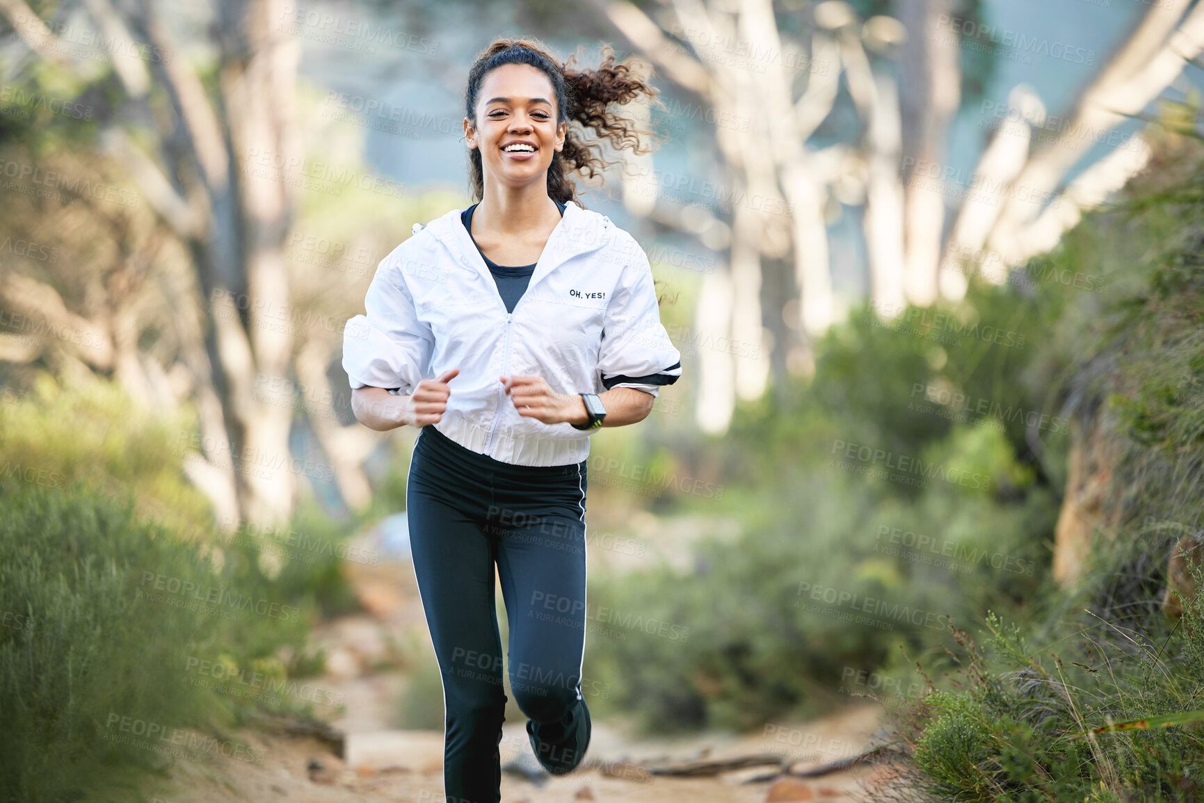 Buy stock photo Woman, running and forest with smile for workout health or exercise cardio for performance, summer or mountain path. Female person, park and weight loss routine in woods for sports, training or trees