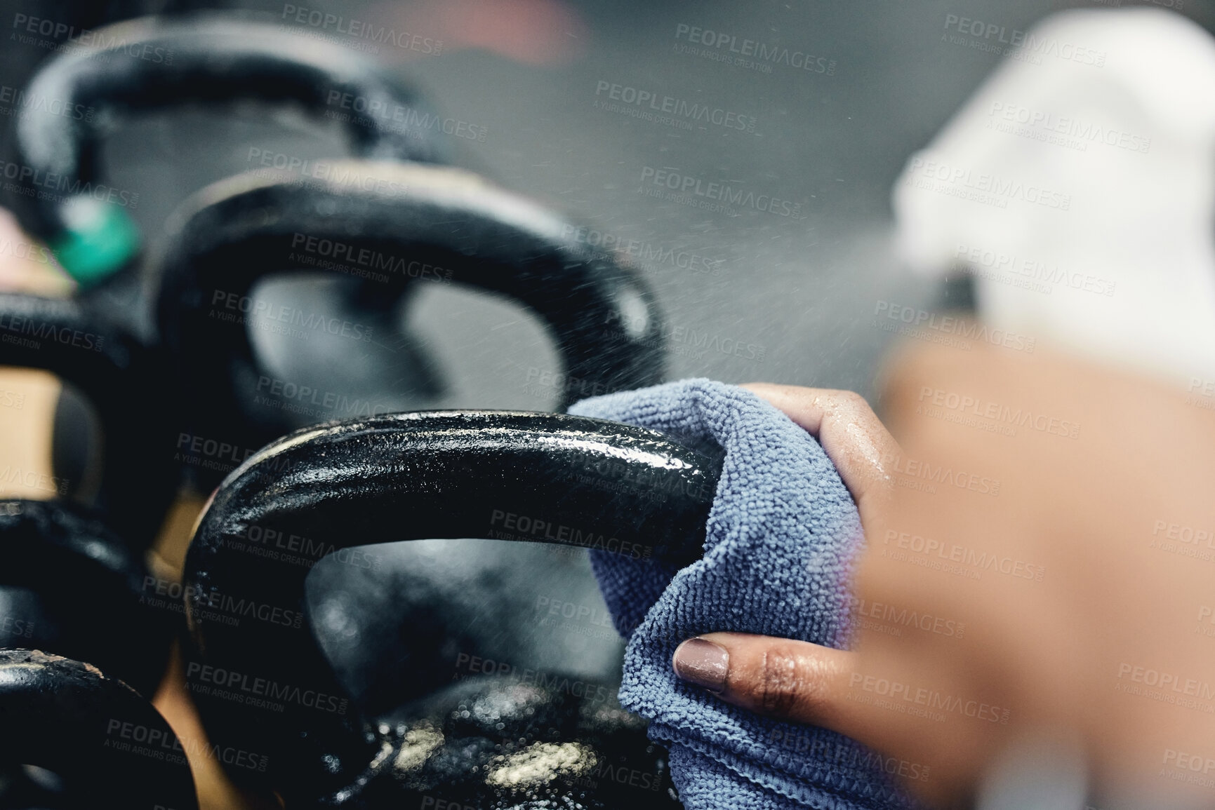 Buy stock photo Cleaning, kettlebell and person in gym, safety and maintenance of health, hygiene and wellness. Professional, cleaner and cloth for bacteria, sanitation and dirt on equipment, virus and hands