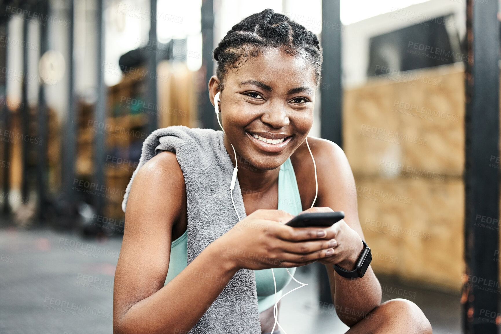 Buy stock photo Exercise, phone for music and portrait of black woman in gym for break from training or workout. Earphones, fitness and smile with happy sports athlete streaming audio in health club for improvement