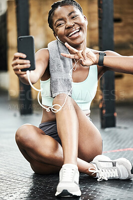 Buy stock photo Selfie, fitness and black girl in gym, earphones and peace sign for sport, social media and conversation on break. Training, practice and music listening with app, smile and relax in weekend