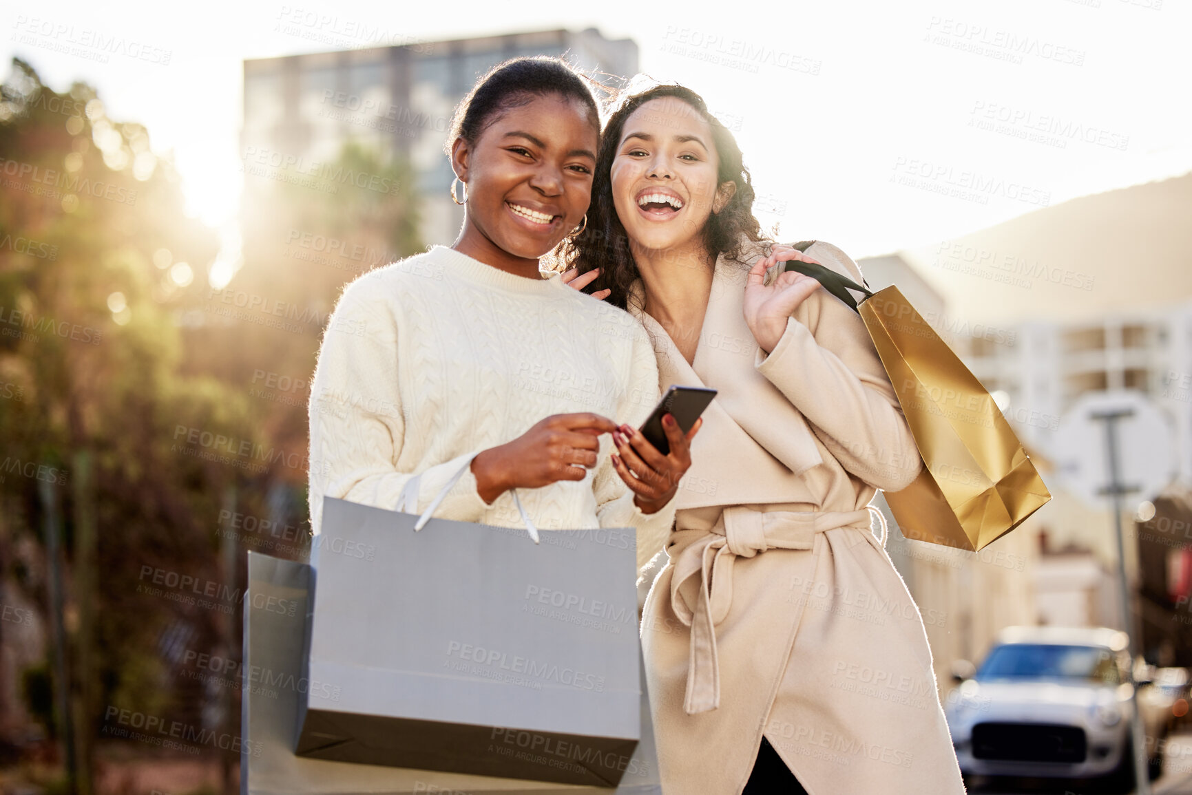 Buy stock photo Portrait, women and paper bag with smartphone for online shopping, sale or retail together outdoor by mall. Happy people, friends and cellphone for ecommerce, discount and deal for fashion or clothes