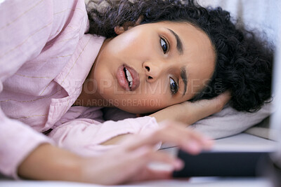 Buy stock photo Woman, smartphone and shocked at morning text in bedroom for communication, message or social media. Female person, mobile tech and head on pillow for reading, missing alarm or lazy weekend at home