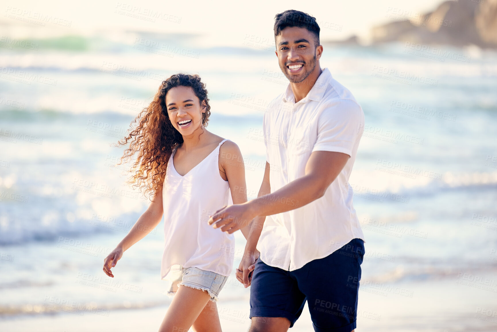 Buy stock photo Portrait, holding hands and happy couple at beach on holiday, vacation or summer travel outdoor. Smile, woman and man walk at ocean for adventure date, love or laughing for connection together by sea