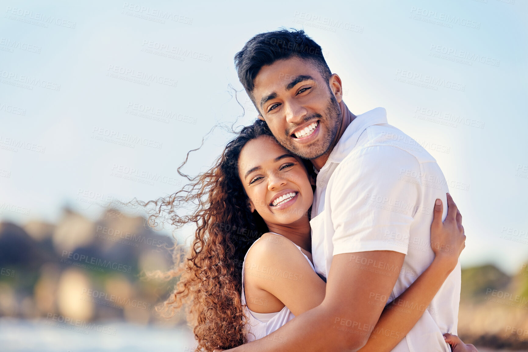 Buy stock photo Portrait, couple and hug on beach with smile, anniversary and trust by ocean for holiday in Bali. Happy man, woman and embrace on seaside with care for romance, relaxing and adventure on island