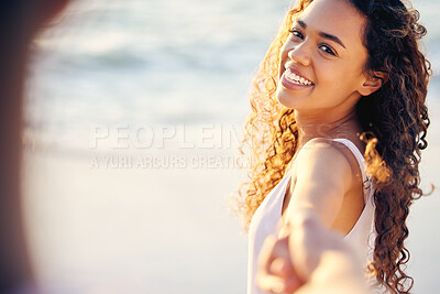 Buy stock photo Cropped shot of a young couple enjoying a day at the beach