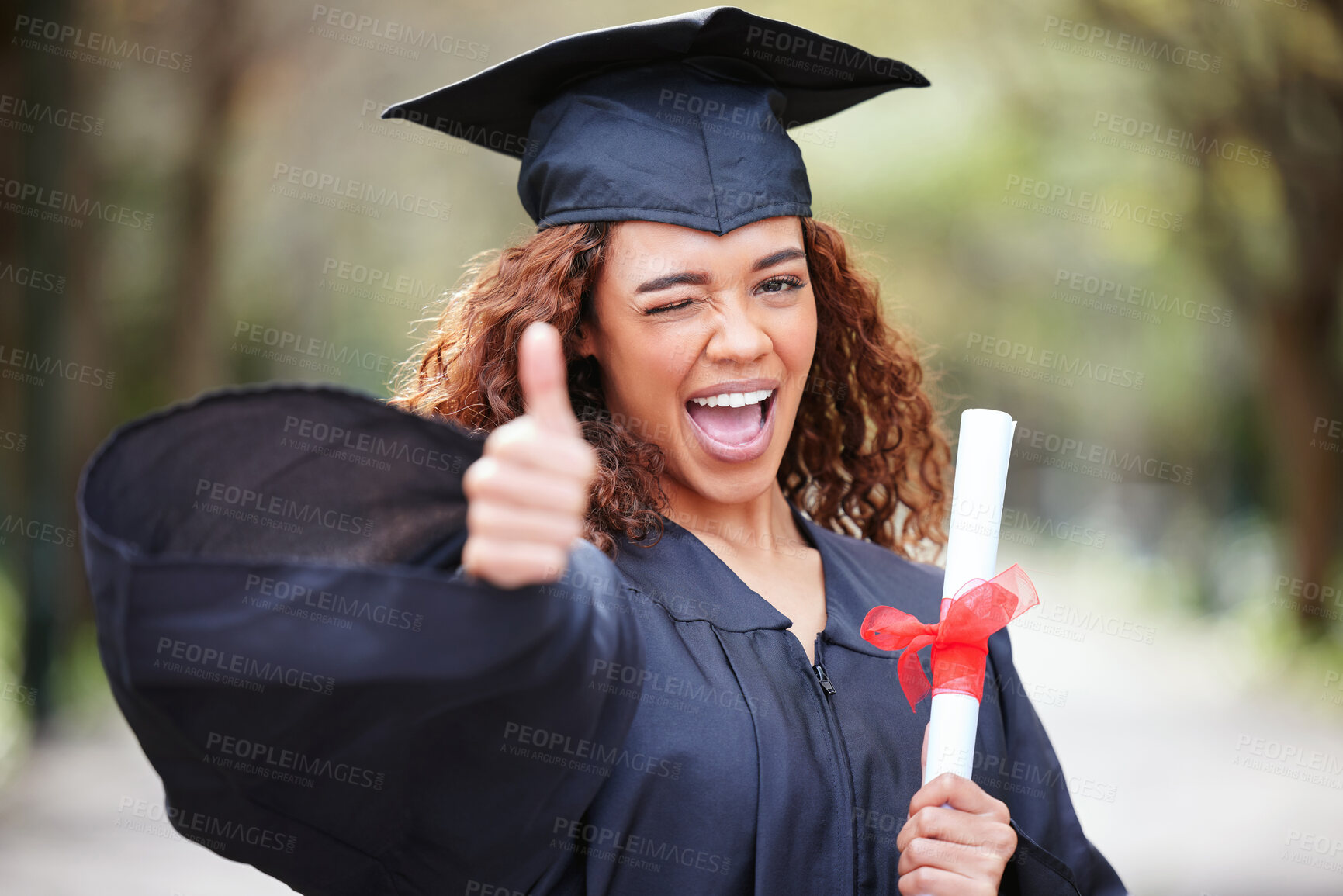 Buy stock photo Thank you, portrait of college student with thumbs up and winking for success at her campus outdoors. Achievement, graduate and female person with her certificate or diploma at university outside