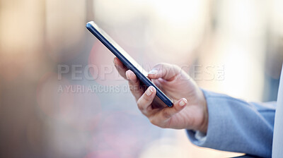 Buy stock photo Cropped shot of an unrecognizable businessman using his cellphone outside