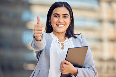 Buy stock photo Shot of an attractive young businesswoman standing alone outside and showing a thumbs up