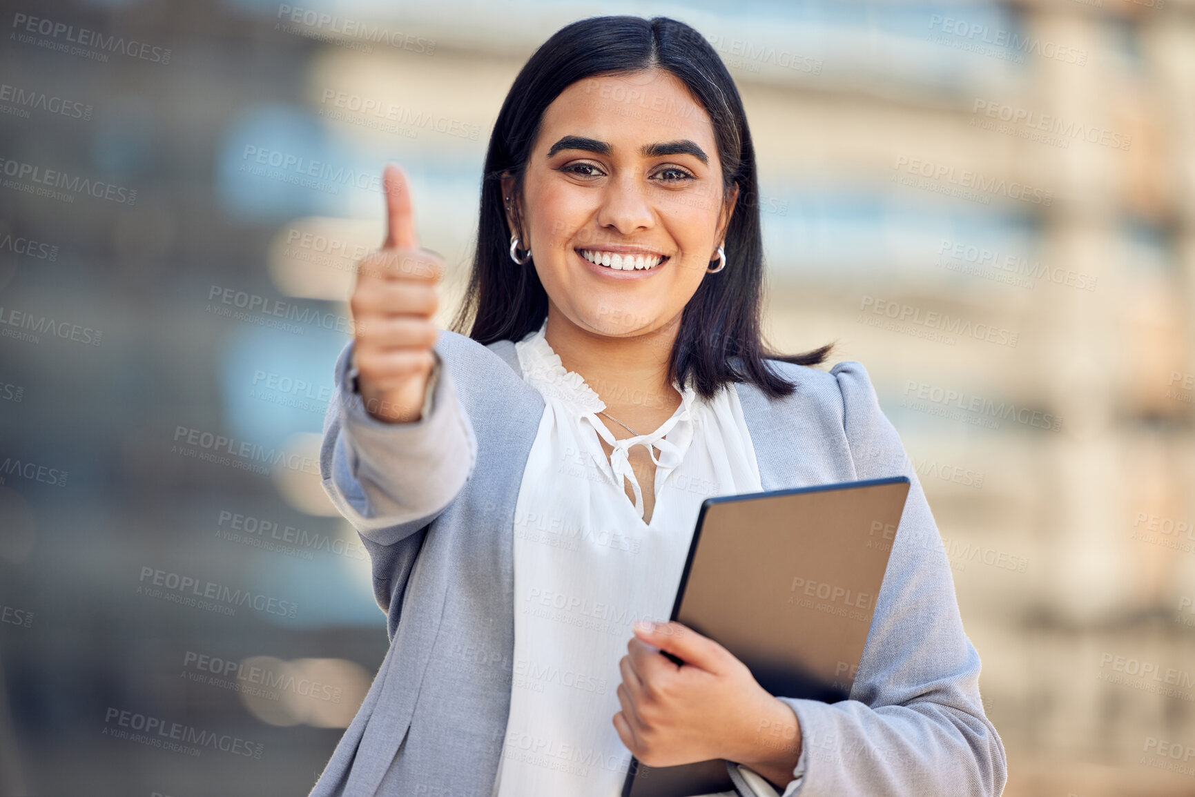 Buy stock photo Shot of an attractive young businesswoman standing alone outside and showing a thumbs up